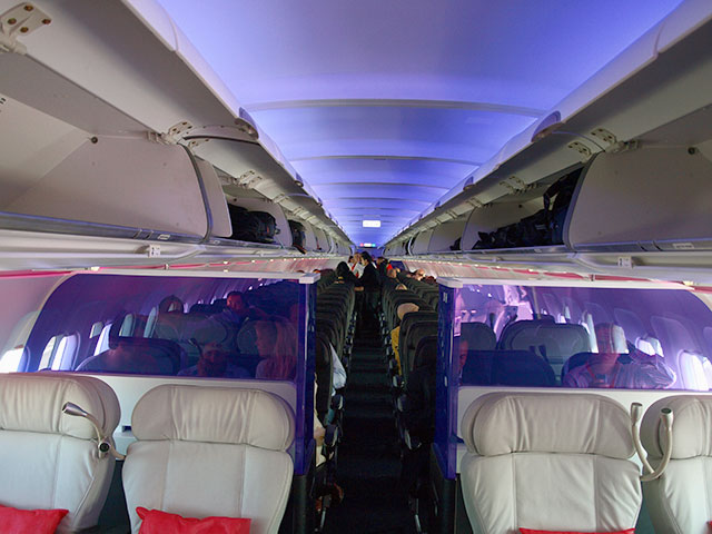 Interior of Virgin America cabin with purple mood lighting