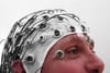 Photo of a man wearing an EEG cap