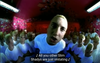 Screen grab from the Real Slim Shady video. Eminem leans into the camera, surrounded by a crowd of imitation Eminems