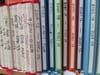 A photograph showing a row of notebooks on a shelf, each labeled with a range of dates, stretching from 2018 to 2023