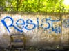 graffiti on a wall spelling out the word Resist