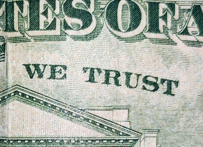 closeup of "we trust" on a $20 bill